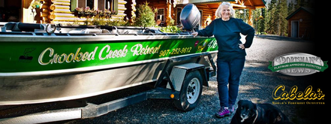 Crooked Creek boat in front of lodge.